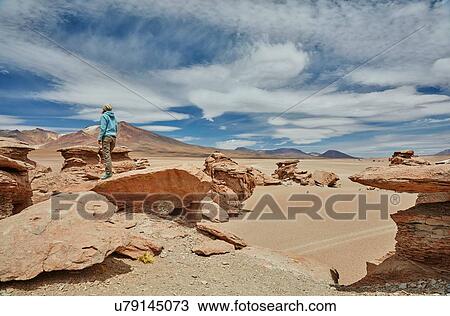 Woman standing on rock, looking at view, Villa Alota, Potosi, Bolivia, South America View Large Photo Image Stock Image - Woman standing on rock, looking at view, Villa Alota, Potosi, Bolivia, South America. Fotosearch