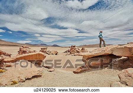 Woman standing on rock, looking at view, Villa Alota, Potosi, Bolivia, South America View Large Photo Image Stock Photography - Woman standing on rock, looking at view, Villa Alota, Potosi, Bolivia, South America. Fotosearch