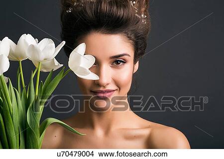 Woman wearing tiara holding tulips View Large Photo Image Picture - Woman wearing tiara holding tulips. Fotosearch