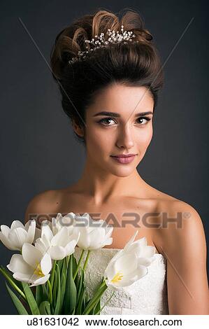 Woman wearing tiara holding tulips View Large Photo Image Stock Image - Woman wearing tiara holding tulips. Fotosearch