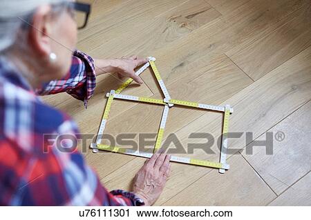 Woman with house shaped tape measure on floor View Large Photo Image Stock Image - Woman with house shaped tape measure on floor. Fotosearch