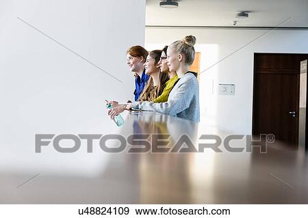 Women leaning on low wall View Large Photo Image Stock Photo - Women leaning on low wall. Fotosearch