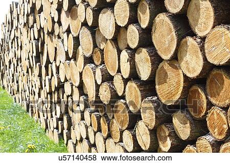 Stock Photo - Woodpile on grass.. Fotosearch