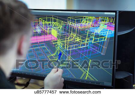 Stock Photo - Worker looking at CAD wireframe industrial design on screen. Fotosearch