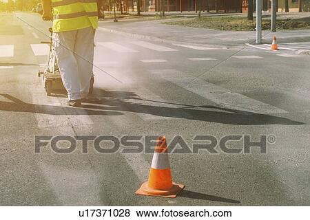 Worker painting pedestrian crossing. View Large Photo Image Stock Photo - Worker painting pedestrian crossing.. Fotosearch
