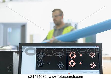 Worker putting roll of vinyl in cutting machine with graphic display on computer in factory View Large Photo Image Stock Image - Worker putting roll of vinyl in cutting machine with graphic display on computer in factory. Fotosearch