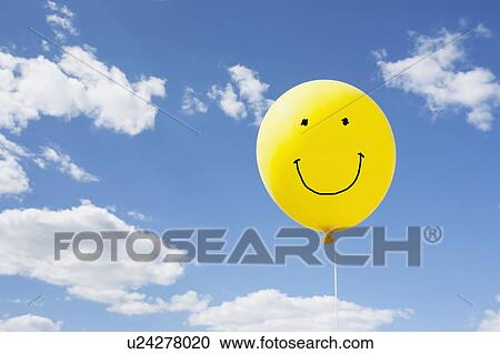 Stock Image - Yellow balloon in blue sky. Fotosearch