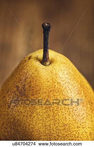 Picture - Yellow pear on wooden table.. Fotosearch