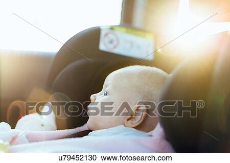 Stock Image - Young baby in car seat in car, close-up. Fotosearch