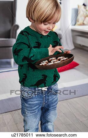 Young boy holding plate of cookies View Large Photo Image Stock Image - Young boy holding plate of cookies. Fotosearch