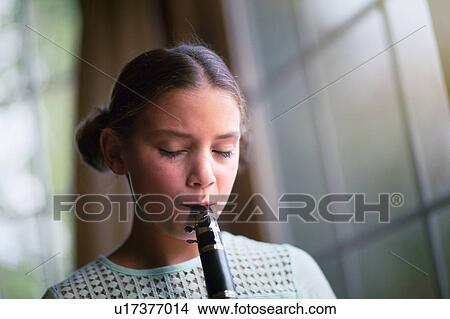 Young clarinettist playing her clarinet View Large Photo Image Picture - Young clarinettist playing her clarinet. Fotosearch