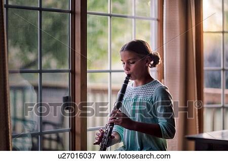 Stock Photo - Young clarinettist playing her clarinet. Fotosearch