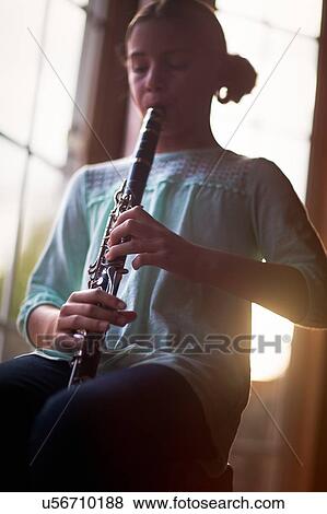 Stock Photo - Young clarinettist playing her clarinet. Fotosearch