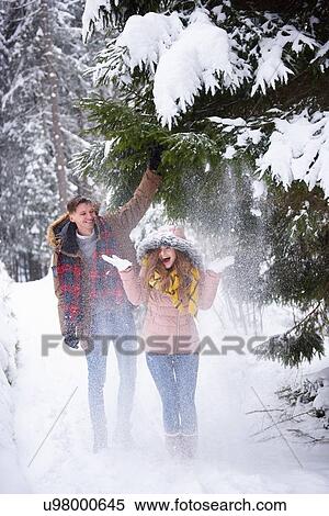 Young couple playing in snow View Large Photo Image Stock Photography - Young couple playing in snow. Fotosearch