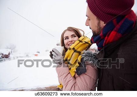Young couple relaxing outdoors in winter View Large Photo Image Stock Image - Young couple relaxing outdoors in winter. Fotosearch