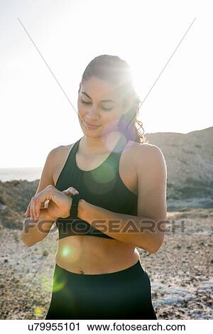 Young female runner checking smartwatch near coast, Las Palmas, Canary Islands, Spain View Large Photo Image Stock Image - Young female runner checking smartwatch near coast, Las Palmas, Canary Islands, Spain. Fotosearch