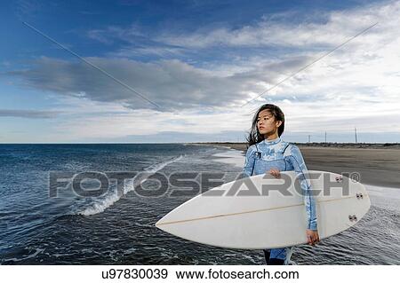 Young female surfer on beach, Tarragona, Catalonia, Spain View Large Photo Image Stock Photo - Young female surfer on beach, Tarragona, Catalonia, Spain. Fotosearch