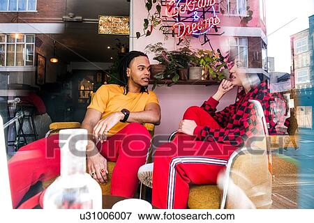 Young friends chatting in bar View Large Photo Image Stock Photo - Young friends chatting in bar. Fotosearch