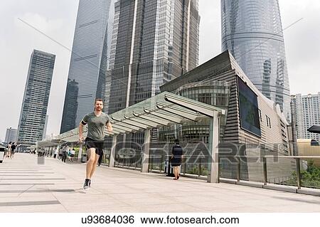 Young male runner running in Shanghai financial centre, Shanghai, China View Large Photo Image Stock Photograph - Young male runner running in Shanghai financial centre, Shanghai, China. Fotosearch
