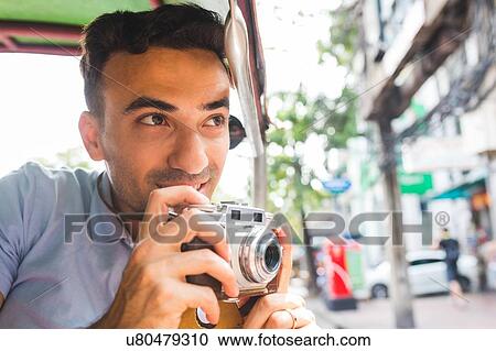 Young male tourist in auto rickshaw with camera, Bangkok, Thailand View Large Photo Image Stock Image - Young male tourist in auto rickshaw with camera, Bangkok, Thailand. Fotosearch