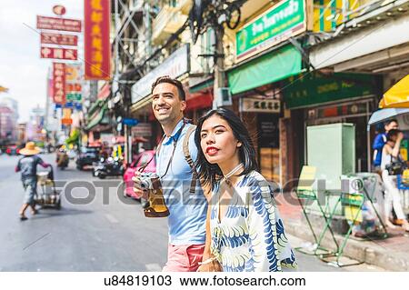 Young tourist couple crossing street, Bangkok, Thailand View Large Photo Image Stock Image - Young tourist couple crossing street, Bangkok, Thailand. Fotosearch