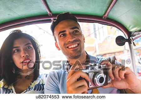 Young tourist couple in auto rickshaw with camera, Bangkok, Thailand View Large Photo Image Stock Image - Young tourist couple in auto rickshaw with camera, Bangkok, Thailand. Fotosearch