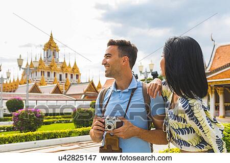 Young tourist couple visiting temple, Bangkok, Thailand View Large Photo Image Stock Photo - Young tourist couple visiting temple, Bangkok, Thailand. Fotosearch