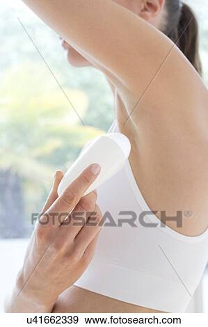 Young woman applying underarm deodorant, close up. View Large Photo Image Stock Photo - Young woman applying underarm deodorant, close up.. Fotosearch