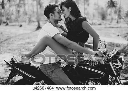 Young woman astride boyfriend on motorcycle, Krabi, Thailand, B&W View Large Photo Image Picture - Young woman astride boyfriend on motorcycle, Krabi, Thailand, B&W. Fotosearch