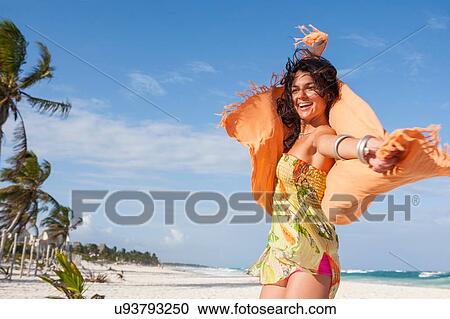 Young woman dancing on beach holding up sarong, Tulum, Quintana Roo, Mexico View Large Photo Image Stock Image - Young woman dancing on beach holding up sarong, Tulum, Quintana Roo, Mexico. Fotosearch