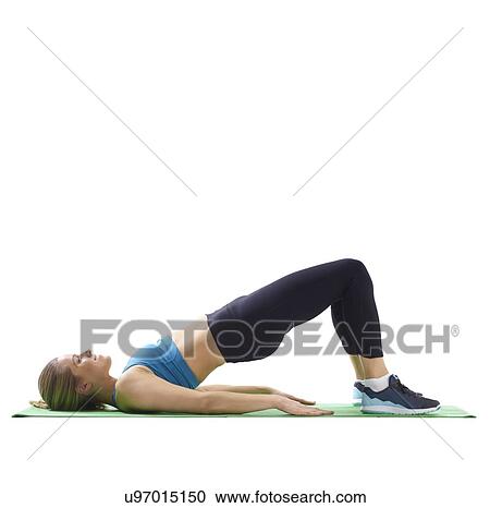 Stock Image - Young woman doing bridge, side view.. Fotosearch