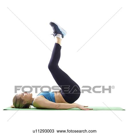 Stock Image - Young woman doing leg lifts, side view.. Fotosearch