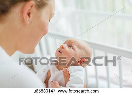 Young woman face to face with baby daughter, cropped View Large Photo Image Stock Photo - Young woman face to face with baby daughter, cropped. Fotosearch