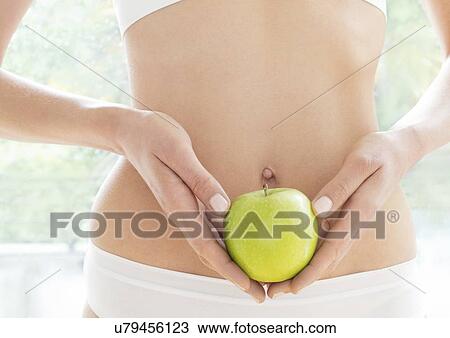Young woman holding green apple, close up. View Large Photo Image Stock Image - Young woman holding green apple, close up.. Fotosearch