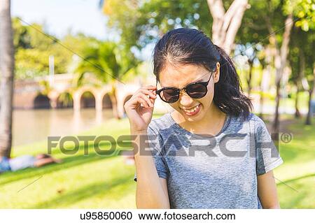 Young woman in park, Bangkok, Thailand View Large Photo Image Stock Image - Young woman in park, Bangkok, Thailand. Fotosearch