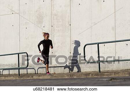 Young woman jogging View Large Photo Image Stock Image - Young woman jogging. Fotosearch