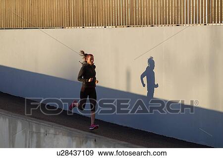 Stock Photo - Young woman jogging. Fotosearch