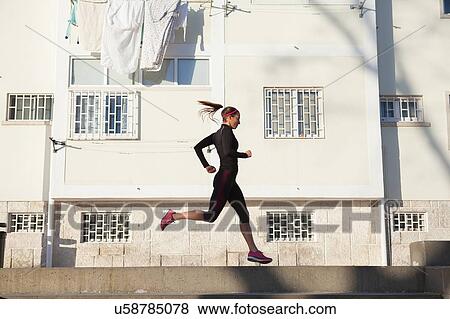 Young woman jogging View Large Photo Image Stock Photo - Young woman jogging. Fotosearch