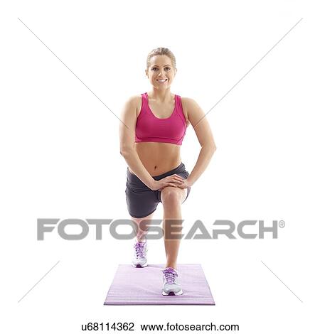 Young woman lunging and stretching hip flexor, studio shot. View Large Photo Image Stock Image - Young woman lunging and stretching hip flexor, studio shot.. Fotosearch