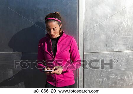 Young woman texting on smartphone View Large Photo Image Stock Image - Young woman texting on smartphone. Fotosearch