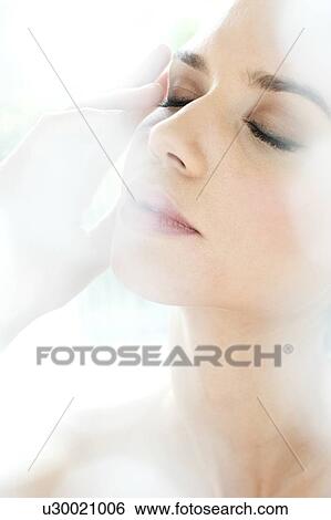 Young woman touching head, portrait. View Large Photo Image Stock Photograph - Young woman touching head, portrait.. Fotosearch