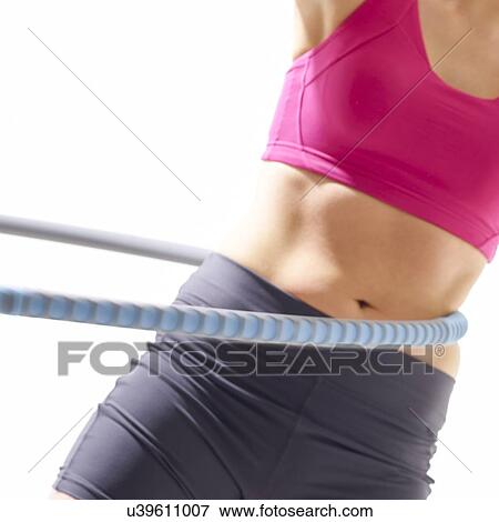 Young woman using plastic hoop, studio shot. View Large Photo Image Stock Photo - Young woman using plastic hoop, studio shot.. Fotosearch