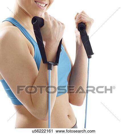 Young woman using resistance band, studio shot. View Large Photo Image Stock Image - Young woman using resistance band, studio shot.. Fotosearch
