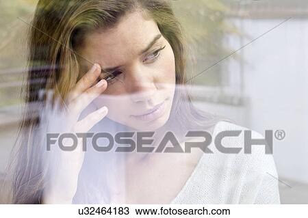 Young woman with hand on head looking away. View Large Photo Image Stock Image - Young woman with hand on head looking away.. Fotosearch