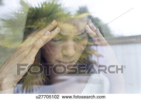 Stock Image - Young woman with hands on head.. Fotosearch