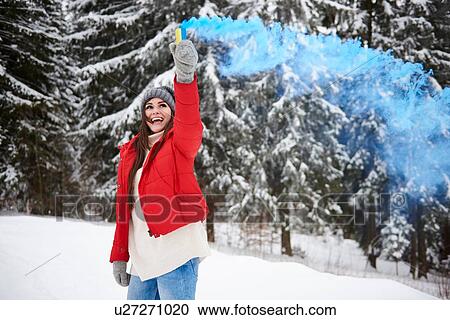 Young woman with smoke flare in snow View Large Photo Image Stock Image - Young woman with smoke flare in snow. Fotosearch