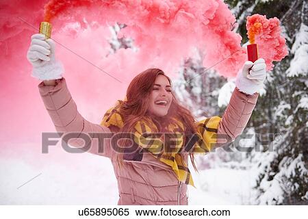 Young woman with smoke flare in snow View Large Photo Image Stock Photography - Young woman with smoke flare in snow. Fotosearch