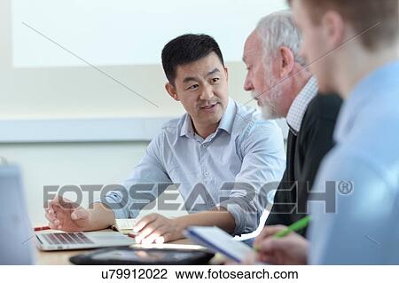 Younger and older scientists discussing pharmaceutical science project in meeting room View Large Photo Image Stock Image - Younger and older scientists discussing pharmaceutical science project in meeting room. Fotosearch