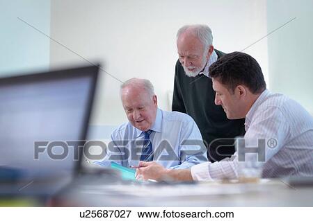Younger and older scientists discussing pharmaceutical science project in meeting room View Large Photo Image Stock Photo - Younger and older scientists discussing pharmaceutical science project in meeting room. Fotosearch