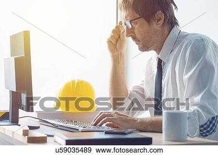 Stock Photo - Architect working in office.. Fotosearch
